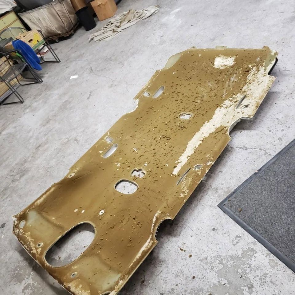 Headliner board before reupholstery, with old foam and glue residue