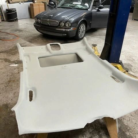 Jaguar headliner board after replacement, recovered in new light gray fabric