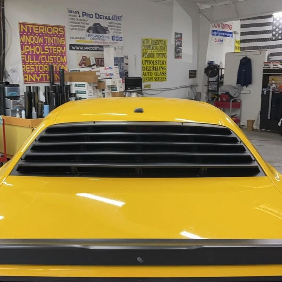 Yellow Dodge Challenger rear window after custom louver install