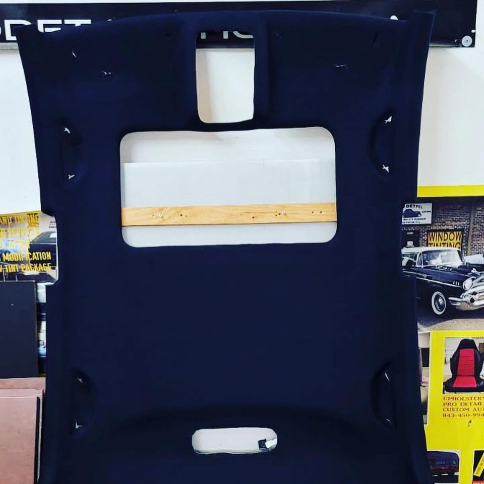 Headliner board after being recovered in navy blue fabric