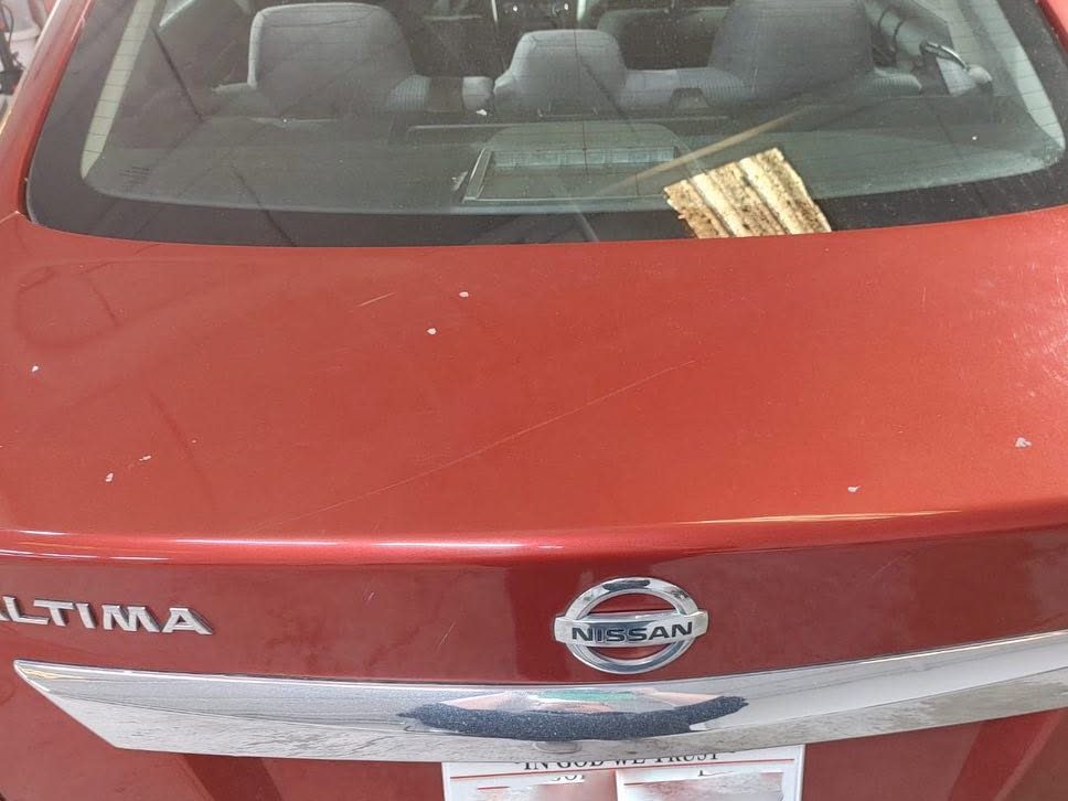 Nissan Altima trunk lid with spots and scratches before paint correction