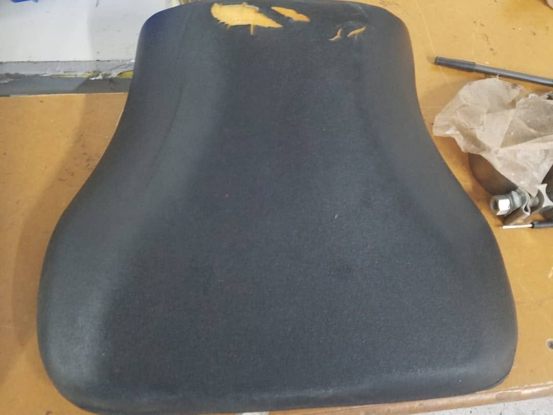 Torn seat before reupholstery